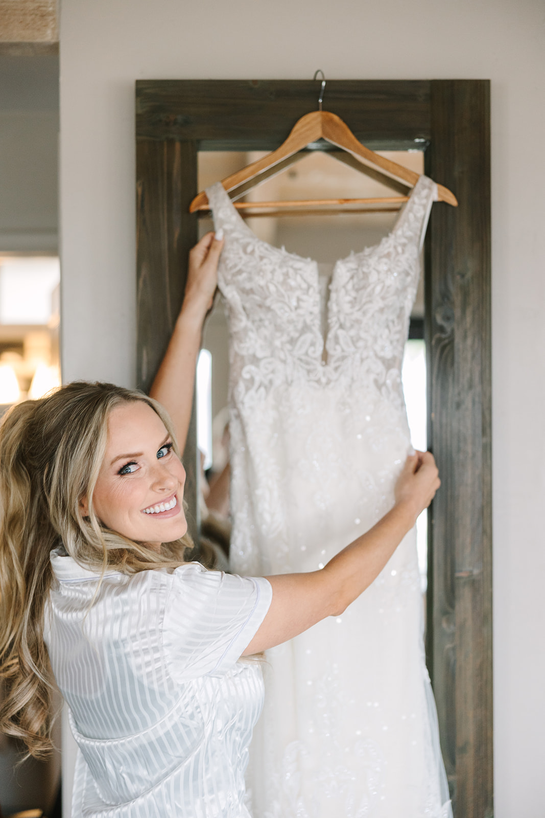 bride getting ready with wedding dress