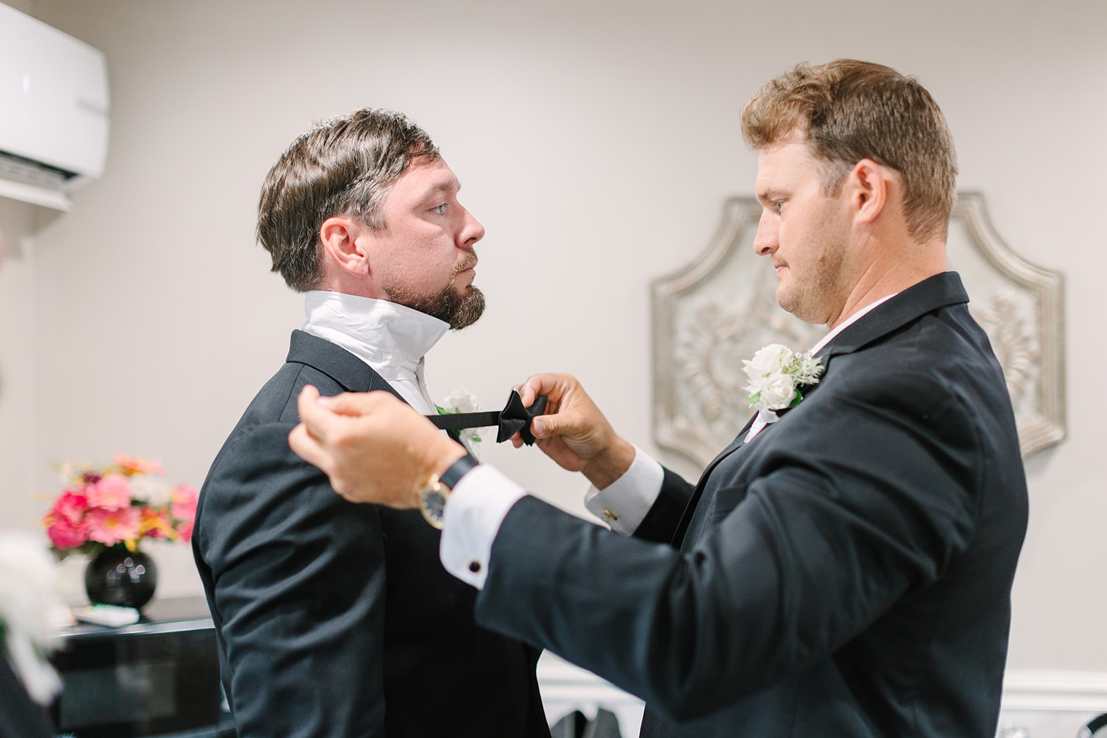 groom putting on bow tie