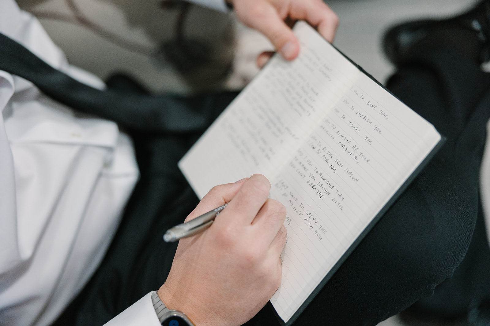 groom writing vows before ceremony